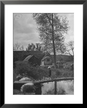 Little Boy Crossing The Bridge Over The Stream At Winson Mill Farm, A War Nursery by Hans Wild Pricing Limited Edition Print image