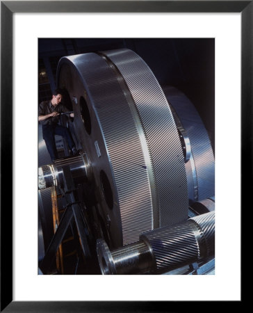 Man Dwarfed By Gigantic Gears He Is Working On For The Navy, At General Electric Plant In Us by Dmitri Kessel Pricing Limited Edition Print image