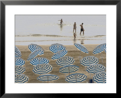Umbrellas On The Beach, Family In The Sea, Jesolo, Venetian Lagoon, Veneto, Italy by James Emmerson Pricing Limited Edition Print image