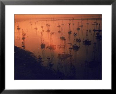 Oil Rigs Dating From The 1920'S Dot The Shallows Of Galveston Bay by Ralph Crane Pricing Limited Edition Print image