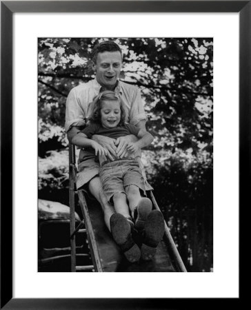 Father And Daughter Playing On Slide During Father's Day At Co-Op Nursery School Owned By Parents by Yale Joel Pricing Limited Edition Print image