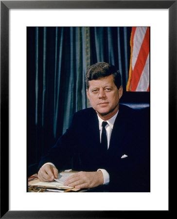 Pres. John F. Kennedy Sitting At His Desk, With Flag In Bkgrd by Alfred Eisenstaedt Pricing Limited Edition Print image