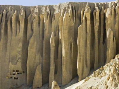 Cliffs With Caves Used As Buddhist Retreats, In Mustang, Nepal by Stephen Sharnoff Pricing Limited Edition Print image