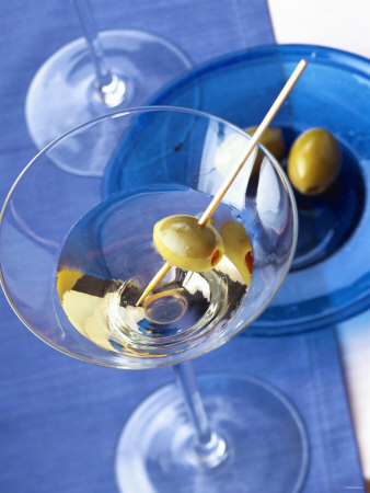 A Glass Of Martini Cocktail With Green Olive by Achim Deimling-Ostrinsky Pricing Limited Edition Print image