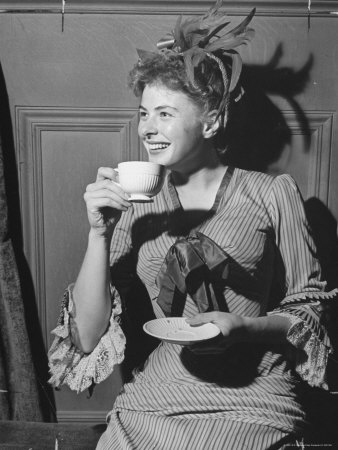 Swedish Movie Actress Ingrid Bergman In Costume Enjoying A Cup Of Coffee by Peter Stackpole Pricing Limited Edition Print image