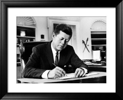 President John F. Kennedy Working At His Desk In The Oval Office Of The White House by Alfred Eisenstaedt Pricing Limited Edition Print image