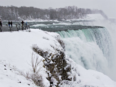 Tourists Looking At The American Falls In The Snow by John Pennock Pricing Limited Edition Print image