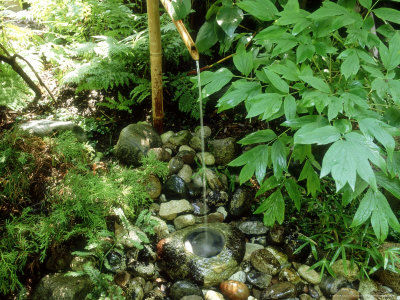 Water Pouring From A Bamboo Spout Into Hollow Stone, In Shady Part Of Garden by Jean-Claude Hurni Pricing Limited Edition Print image