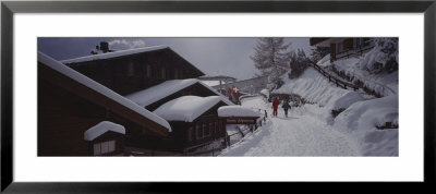 Two People Walking In Snow, Murren, Switzerland by Panoramic Images Pricing Limited Edition Print image
