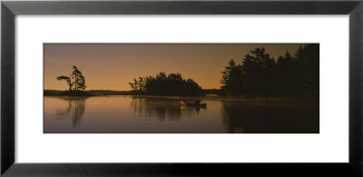 Silhouette Of A Person In A Canoe On A Lake, Kejimkujik Lake, Nova Scotia, Canada by Panoramic Images Pricing Limited Edition Print image