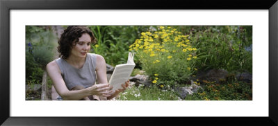 Young Woman Reading A Book In A Garden In A Garden by Panoramic Images Pricing Limited Edition Print image