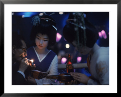 Patron Of Nightclub Uruwashi Having His Cigarette Lit By Geisha by Eliot Elisofon Pricing Limited Edition Print image