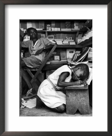 Kneeling Schoolgirl Writing On Wooden Bench. Accura, Gold Coast, Ghana by Alfred Eisenstaedt Pricing Limited Edition Print image