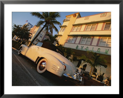 An Antique Car Parked Outside The Art Deco-Style Avalon Hotel by Annie Griffiths Belt Pricing Limited Edition Print image