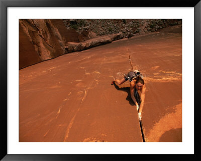 A Young Woman Climbing In Canyonlands National Park by Jimmy Chin Pricing Limited Edition Print image
