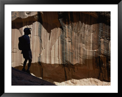 The Shadow Of A Man Graces The Wall Of Anasazi Canyon, Also Known As Mystery Canyon by Bill Hatcher Pricing Limited Edition Print image