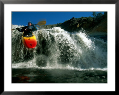 Suspended In Mid-Air, A Kayaker Sails Down A Short Waterfall And Is Headed For The Rapids Below by Barry Tessman Pricing Limited Edition Print image