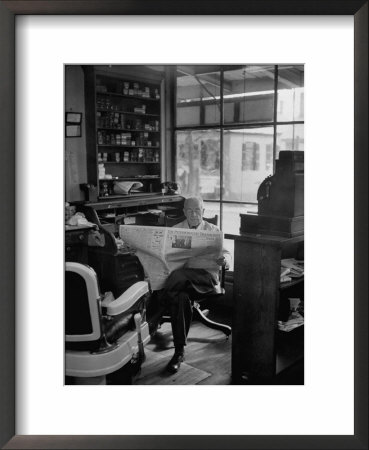 Elderly Barber Sitting Reading The Morning Paper In Small Village Shop In Small New England Town by Yale Joel Pricing Limited Edition Print image