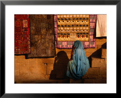 Woman In Sari Sitting In Front Of Rugs For Sale, Jaisalmer, Rajasthan, India by Dallas Stribley Pricing Limited Edition Print image