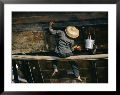 A Chinese Woman Scrubs The Outside Of A Junk by Joe Scherschel Pricing Limited Edition Print image