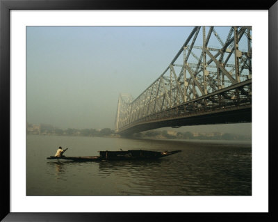 A Man Guides A Boat Under A Bridge On The Hooghly River At Calcutta by Ed George Pricing Limited Edition Print image