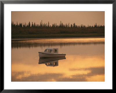An Anchored Boat Floats On The Mackenzie River At Sunset by Raymond Gehman Pricing Limited Edition Print image