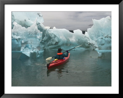 A Kayak Paddler Passes Sculpted Icebergs In Tracy Arm Fjord by Ralph Lee Hopkins Pricing Limited Edition Print image