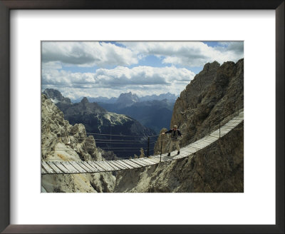 A Man Walking Across A Bridge In The Dolemites, Cortina, Italy by Ed George Pricing Limited Edition Print image