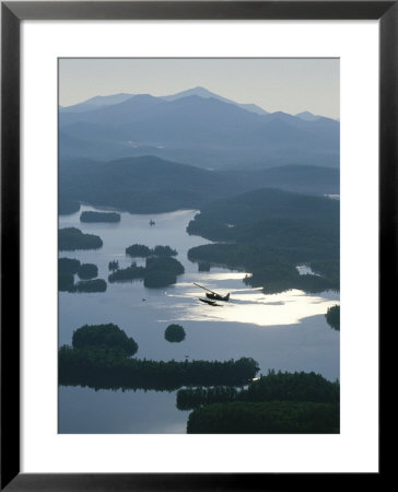 A Floatplane Flies Over Long Lake With Mount Marcy In The Background by James P. Blair Pricing Limited Edition Print image