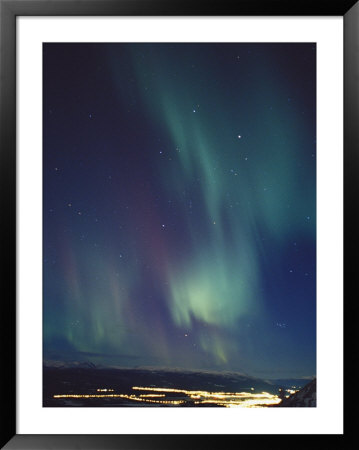 The Aurora Borealis Over A City by Paul Nicklen Pricing Limited Edition Print image