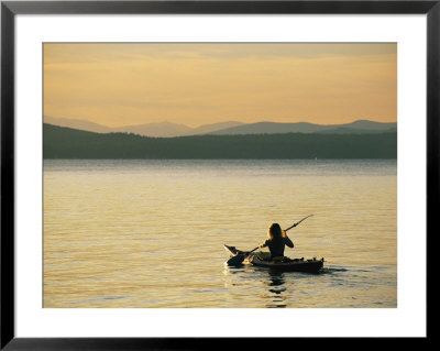 A Kayaker Paddles Across Lake Sebagos Calm Waters In Low Sunlight by Skip Brown Pricing Limited Edition Print image