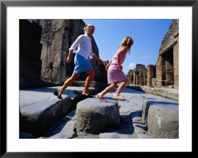 Mother And Daughter Crossing Ancient Street, Pompeii, Italy by Philip & Karen Smith Pricing Limited Edition Print image