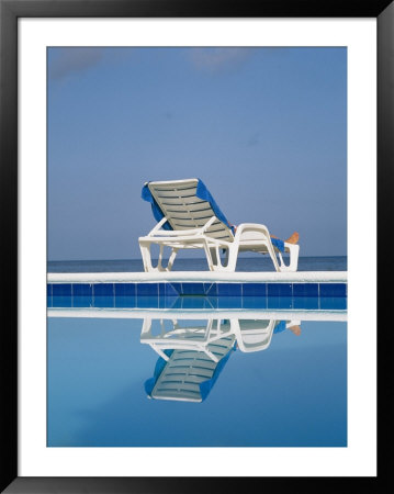 A Deck Chair Offers Poolside Relaxation To A Vacationer by Michael S. Lewis Pricing Limited Edition Print image