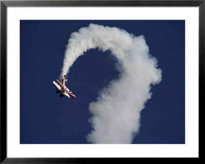 A Sharply Banking Bi-Plane At The Oshkosh Fly-In Air Show by Kenneth Garrett Pricing Limited Edition Print image