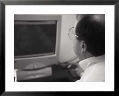 An Accountant Stares At A Computer Screen by Joel Sartore Pricing Limited Edition Print image