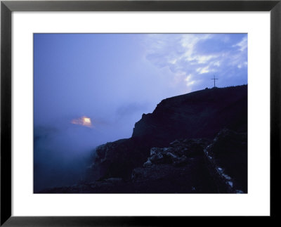 A Cross Stands On A Fog-Shrouded Hill At Sunrise by Raul Touzon Pricing Limited Edition Print image