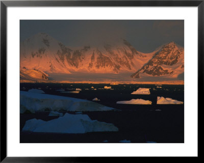 Sunlight Illuminates A Landscape Of Mountains And An Ice-Filled Sea by Maria Stenzel Pricing Limited Edition Print image