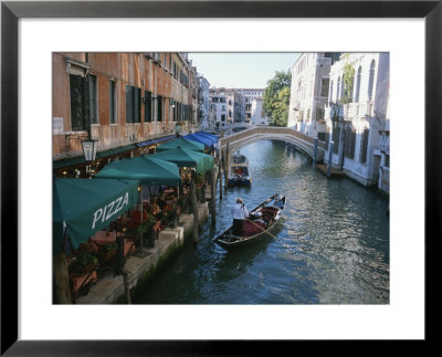 A Gondolier Passes A Restaurant On A Canal In Venice, Italy by Taylor S. Kennedy Pricing Limited Edition Print image