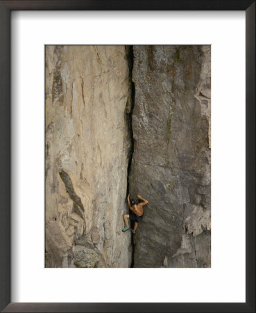 A Shirtless Rock Climber Scales An Almost Vertical Cliff Face On The North Shore Of Lake Superior by Paul Chesley Pricing Limited Edition Print image