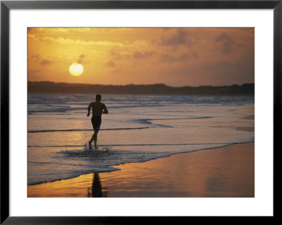 A Man Runs Through The Surf On Shella Beach At Sunset by Bobby Model Pricing Limited Edition Print image