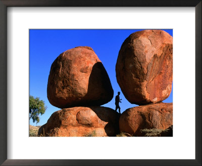 Man Standing In Between Boulders, Devil's Marbles Conservation Reserve, Australia by John Banagan Pricing Limited Edition Print image