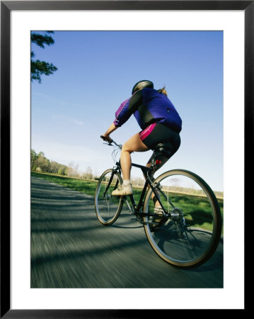 A Bicyclist Rides On A Road by Skip Brown Pricing Limited Edition Print image