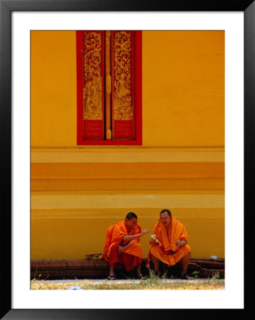 Two Monks Talking, Vientiane, Laos by Frank Carter Pricing Limited Edition Print image