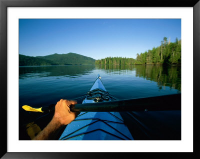 A Kayaker Sails Across This Serene Lake by Barry Tessman Pricing Limited Edition Print image