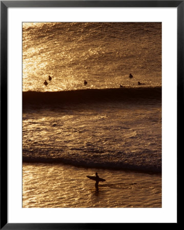 Surfers Riding Waves On The Bukit Badung Peninsula, Bali, Indonesia by Alain Evrard Pricing Limited Edition Print image