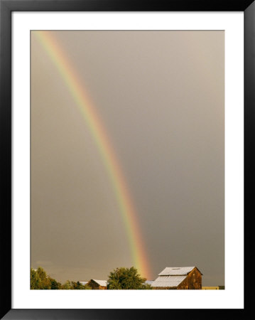 A Rainbow Arches Across The Sky Onto A Cluster Of Farm Buildings by Michael S. Lewis Pricing Limited Edition Print image