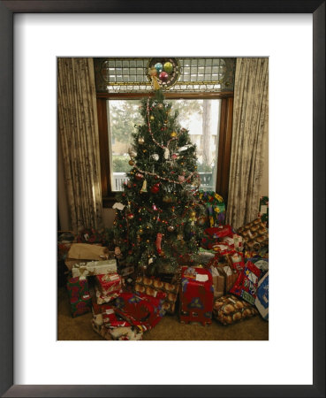 A Decorated Christmas Tree With Wrapped Presents Beneath by Joel Sartore Pricing Limited Edition Print image