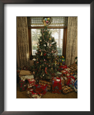 A Decorated Christmas Tree With Wrapped Presents Beneath by Joel Sartore Pricing Limited Edition Print image