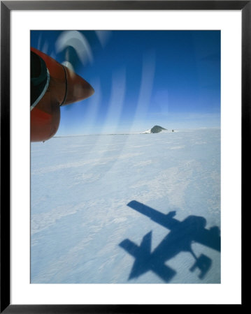 Prop Plane Casts A Shadow On The Ice Below by Gordon Wiltsie Pricing Limited Edition Print image