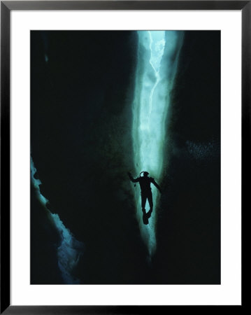 Diver Is Silhouetted In A Lead In The Ice Of Mcmurdo Sound by Bill Curtsinger Pricing Limited Edition Print image